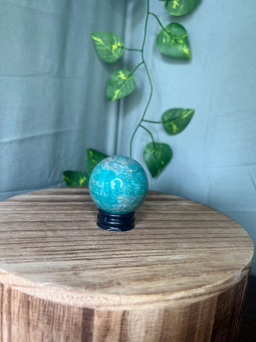 102g natural Amazonite crystal sphere featuring vibrant turquoise-blue colouring with soft white marbling and a polished finish.