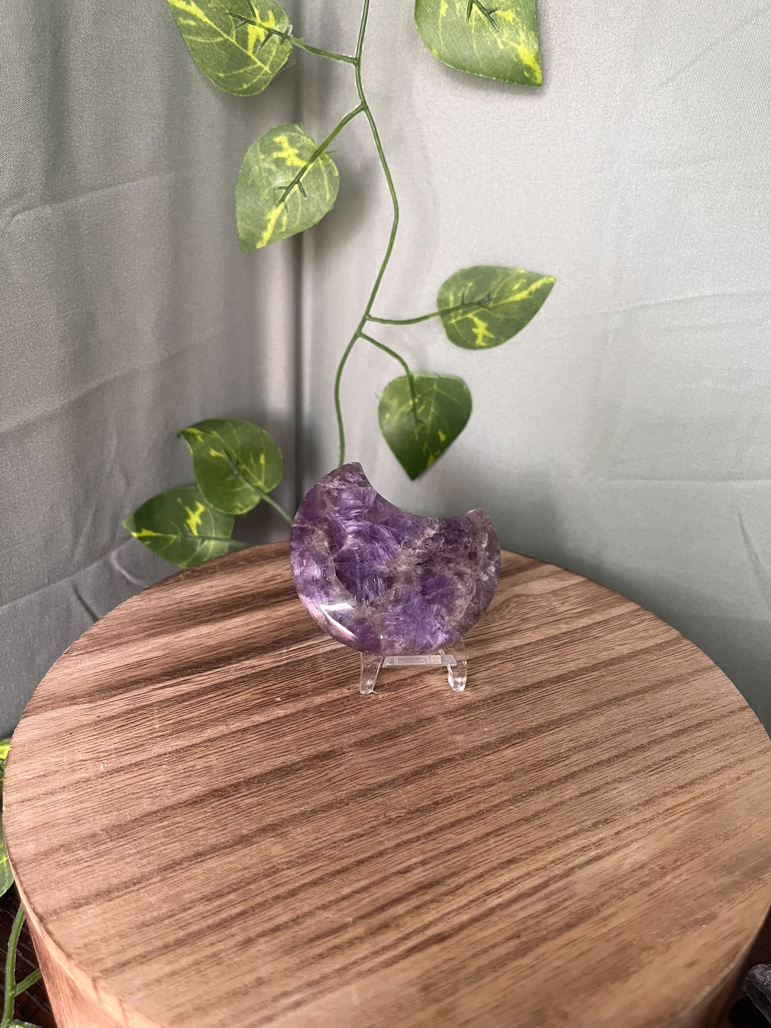58g polished Amethyst crescent moon carving displaying rich purple colour with natural chevron Quartz patterning.