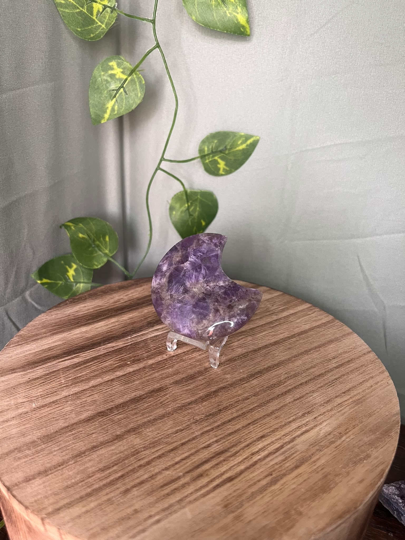 58g polished Amethyst crescent moon carving displaying rich purple colour with natural chevron Quartz patterning.