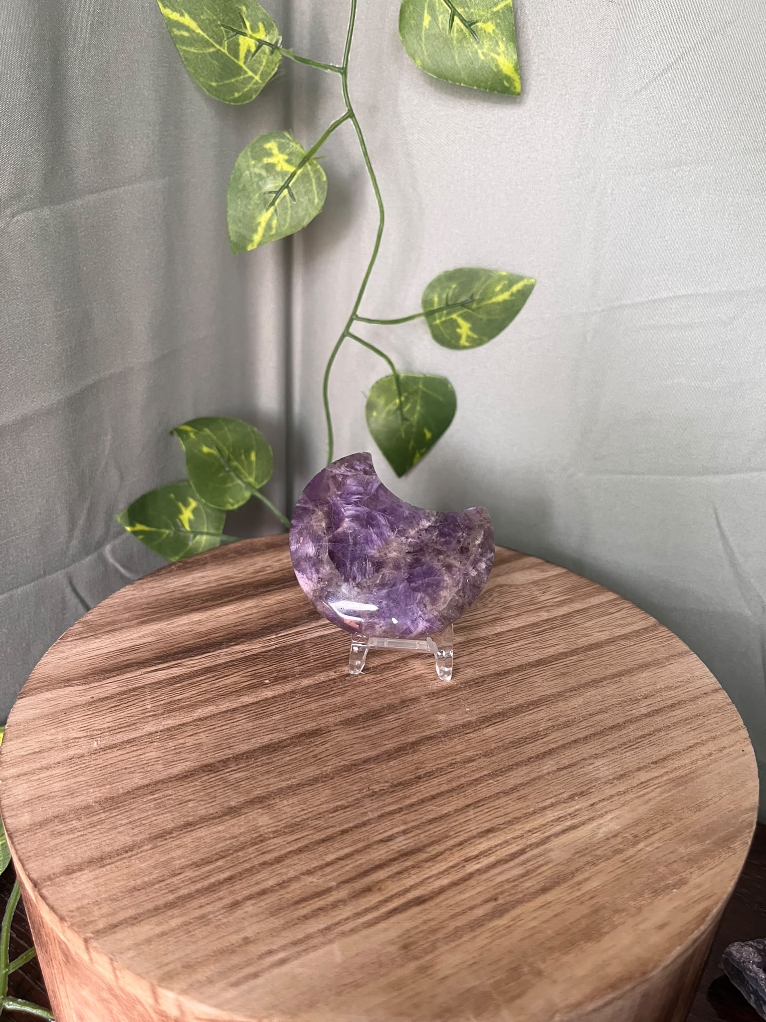 58g polished Amethyst crescent moon carving displaying rich purple colour with natural chevron Quartz patterning.